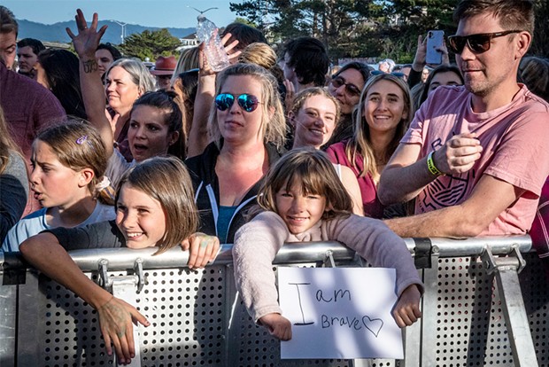 Lots of young girls, some holding signs, moved to get as close as possible to the stage during Sara Bareilles' performance. - PHOTO BY MARK A. LARSON