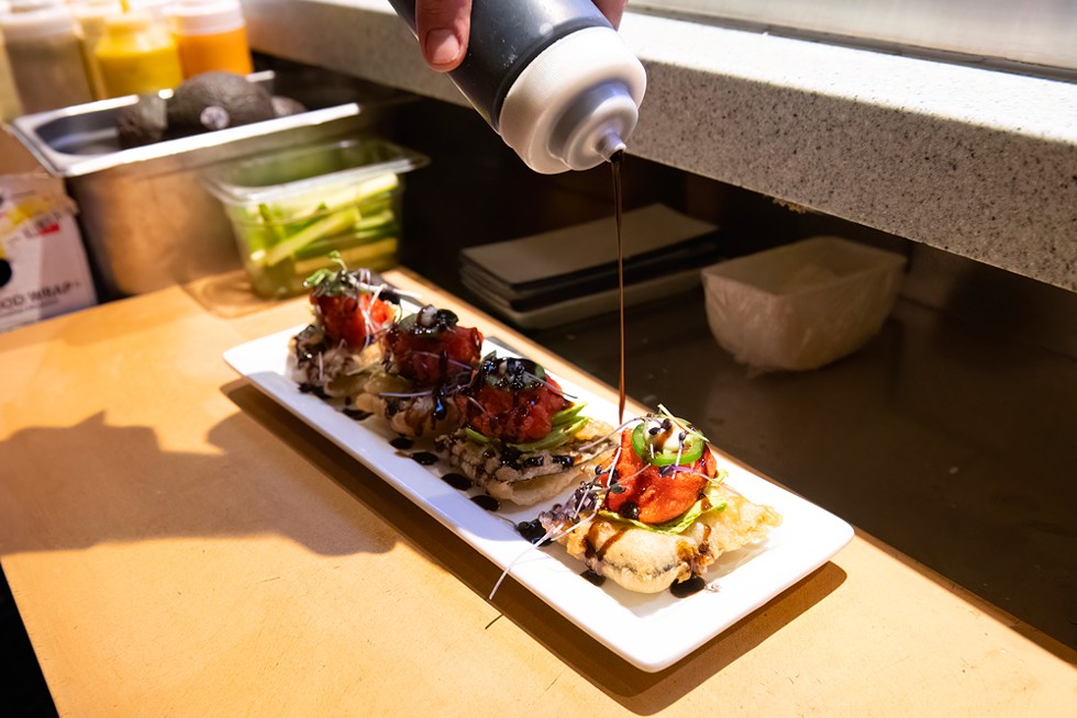 The Tuna Tostada gets a finishing touch. - PHOTO BY MARK MCKENNA