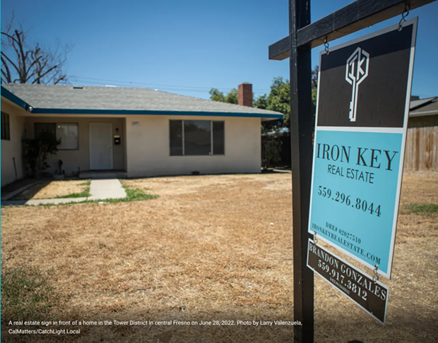 A real estate sign in front of a home in the Tower District in central Fresno on June 28, 2022. - PHOTO BY LARRY VALENZUELA, CALMATTERS/CATCHLIGHT LOCAL