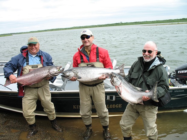 Supreme Court Justice Samuel Alito, center, and hedge fund billionaire Paul Singer, right, hold king salmon with another guest. - PHOTO OBTAINED BY PROPUBLICA