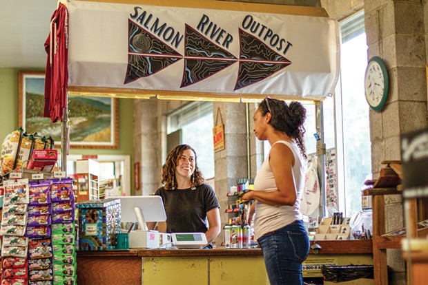 Elly O’Rourke visits with Aja Conrad, owner of On River Time Designs, as she stops in to buy snacks. Conrad is one of the artists who sells her clothing in the store. - PHOTO BY JARRETTE WERK UNDERSCORE NEWS/REPORT FOR AMERICA