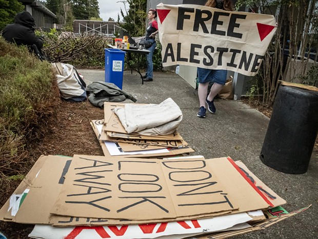 Protest signs sit near a blockaded entrance of Siemens Hall on Tuesday morning. - MARK LARSON