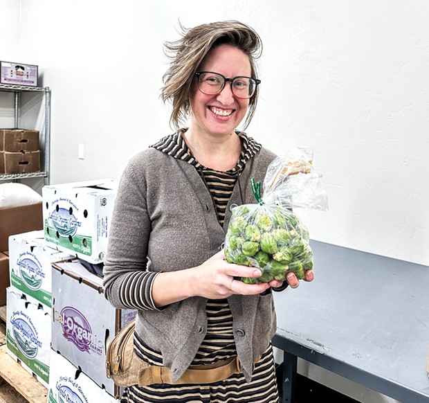 Director of Cooperative Distribution Megan Kenney in the Harvest Hub cold room. - PHOTO BY JENNIFER FUMIKO CAHILL