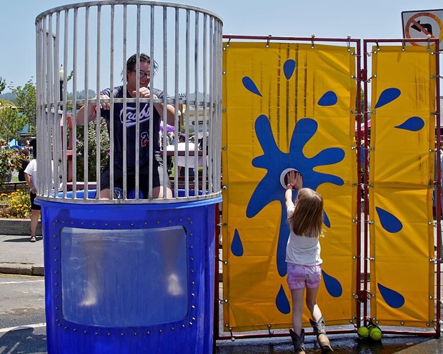 Caleb Nieman takes his turn getting dunked on the Fourth of July. - PHOTO BY MATT FILAR