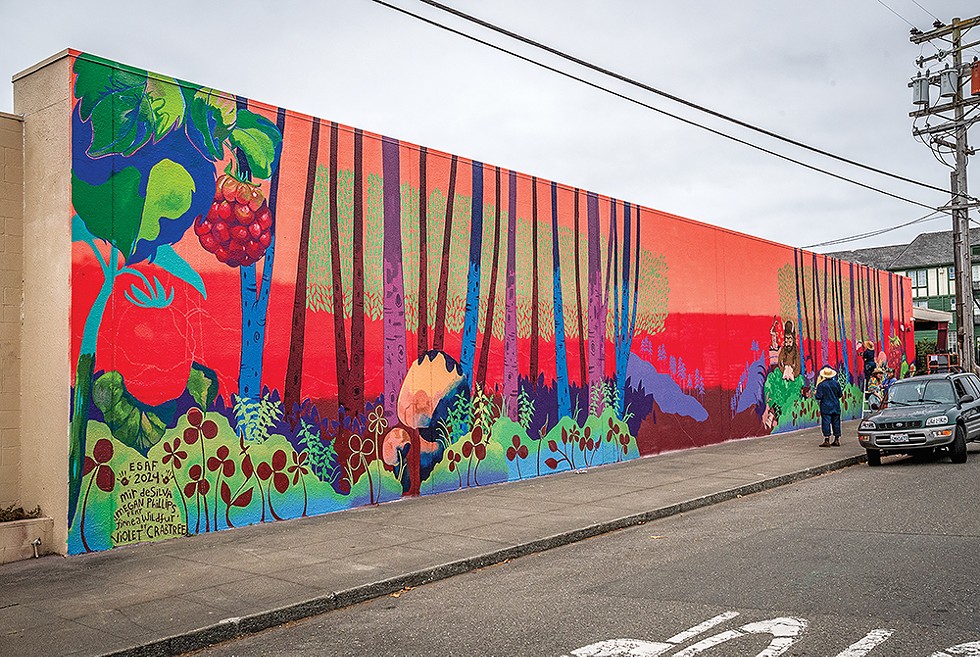 "The Lost Pages" mural on the side wall of Alder Grove Charter School. - PHOTO BY MARK LARSON