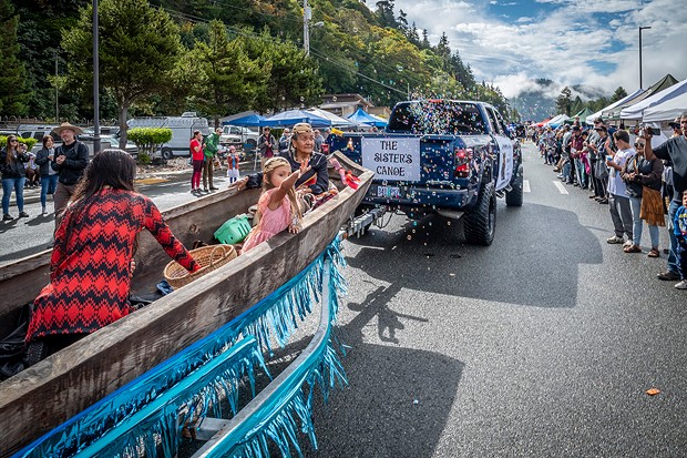 This traditional redwood canoe carried Darlene Rose McGee and others throwing candy to attendees of the Klamath Salmon Festival parade. - PHOTO BY MARK LARSON