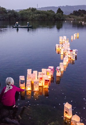 Lanterns float out onto Klopp Lake during the 33rd annual ceremony. - MARK LARSON