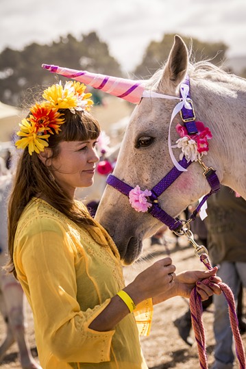 Julie Vinum, of Blue Lake, waited with her "unicorn," Gracie, to begin the Blue Lake Saddle Club's rides for children. It was the first year for the club's petting zoo and horseback ride fundraiser at the Medieval Festival of Courage in Blue Lake on Saturday, Oct. 3. - MARK LARSON