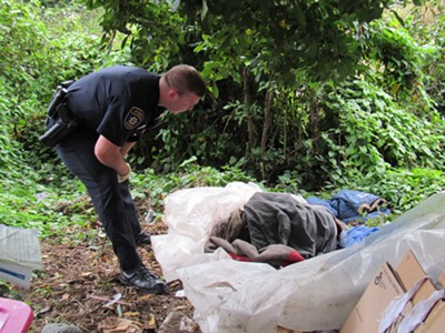 EPD officer contacts a homeless man camped in greenbelt. - LINDA STANSBERRY
