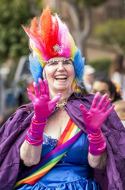 Parade marshal Linda Shapeero brought the color with her Pride ensemble and signature rainbow earrings. - MARK LARSON