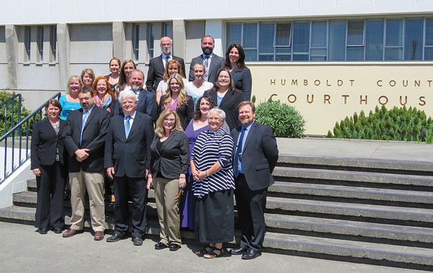 Kevin Robinson, center front, with the rest of the Public Defender staff. - FILE