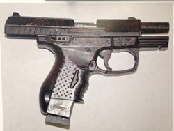 A police photograph of the replica handgun reportedly found on McClain. - FILE