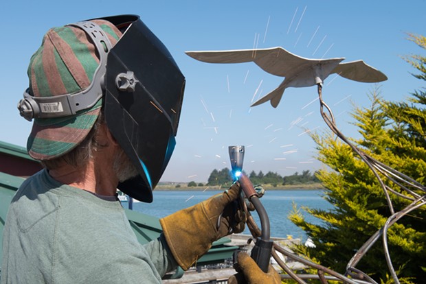 Jack Sewell sparks up the welding torch to put the bird back on "Keeping Up with Current Events." - MARK MCKENNA