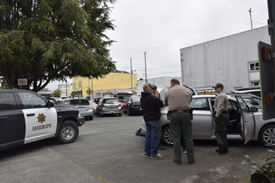 Bob Shinn speaks with deputies at the scene of the traffic stop and subsequent arrests. - THADEUS GREENSON