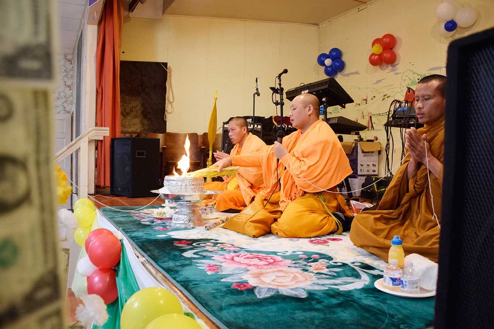 Monks from Wat Lao Saysettha, a Buddhist temple in Santa Rosa, deliver the New Year blessings and prayers. - PHOTOS BY JENNIFER FUMIKO CAHILL