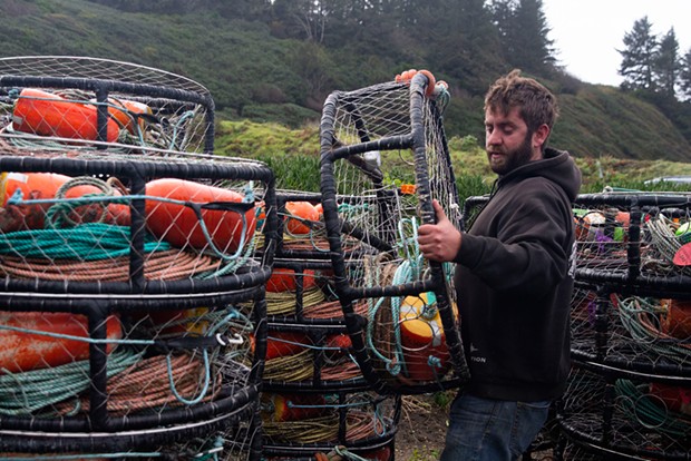 Curt Wilson stacks crab traps in preparation for the opening of the commercial crab season.