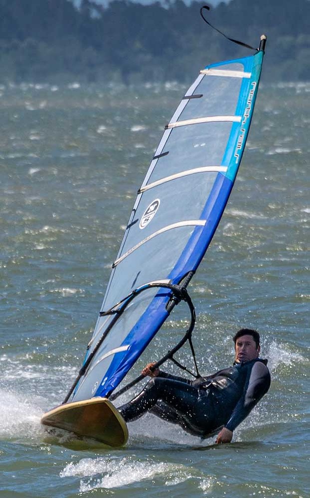 Bohdi Portugal created some serious speed while wind surfing in high winds blowing across Humboldt Bay.