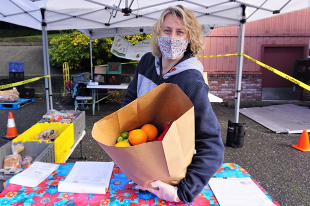 Food for People Mobile Produce Pantry Coordinator Jessica Beyer with a bag of fresh produce at a recent distribution.