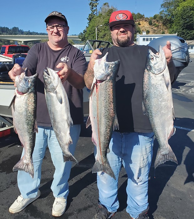Doug and Nick Ebert hold limits of salmon caught Oct. 2 while fishing the Chetco River estuary with guide Mick Thomas of Brookings Fishing Charters.