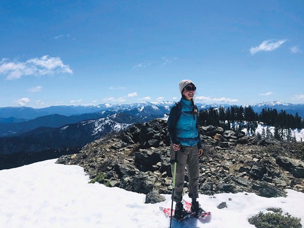 Kelly atop Salmon Mountain in sunshine and snow shoes.