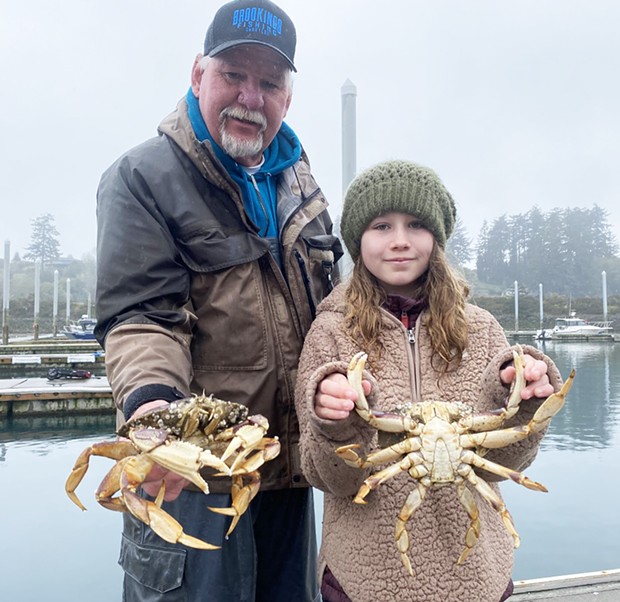 Ron Haynes, a deckhand for Brookings Fishing Charters, and a young customer, hold crab harvested in Brookings earlier this year. The sport crab season will open statewide in California this Saturday with restrictions.
