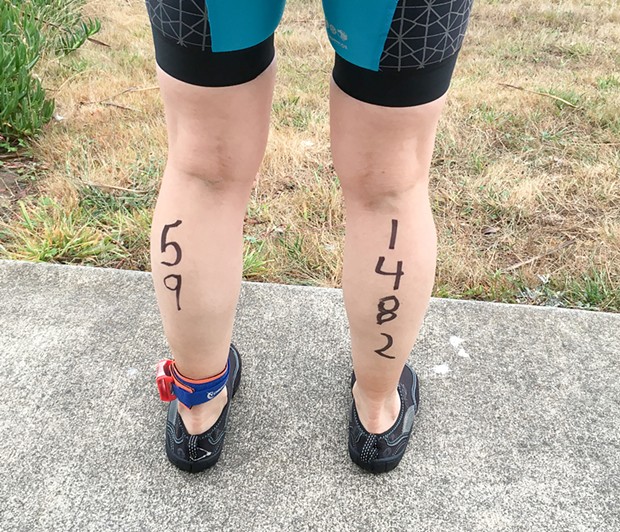 The author's age and triathlon race number written on the backs of her legs before the start.