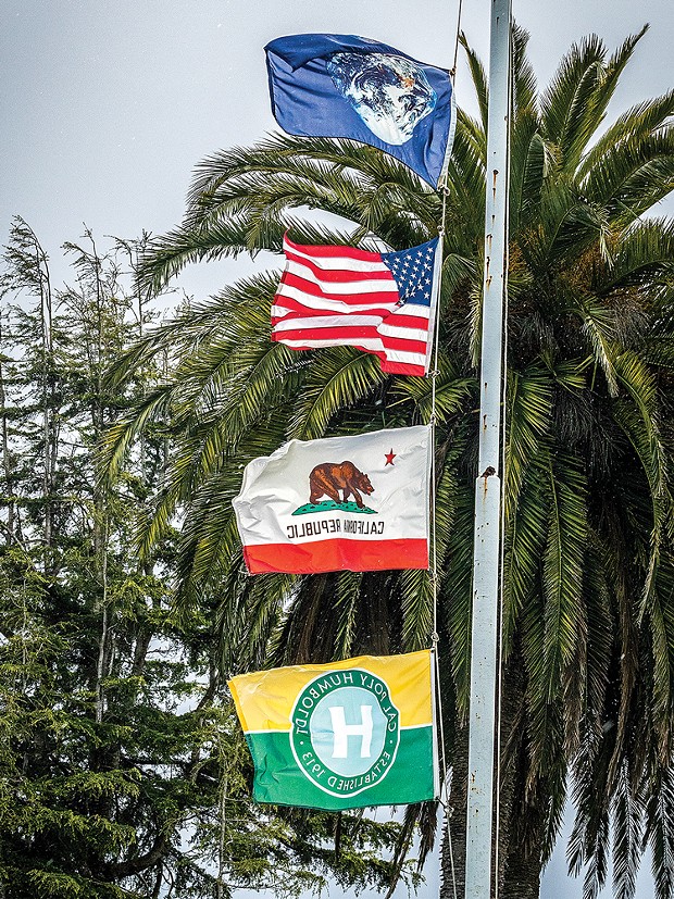 Flags at the Arcata Plaza, with the Earth flag atop those representing the United States, California and Cal Poly Humboldt, fly on March 28.