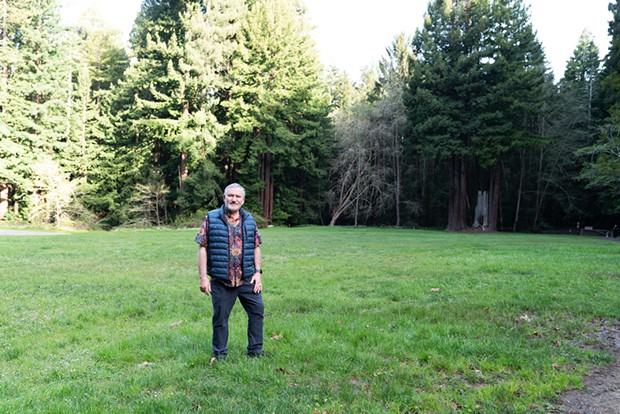 Sacred Groves founder Michael Furniss, who is working to bring a conservation burial option to Humboldt County, in a meadow encircled by trees at Redwood Park.