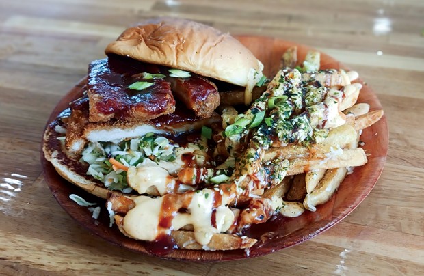 The juicy chicken katsu sandwich accompanied by sauce-drenched fries.