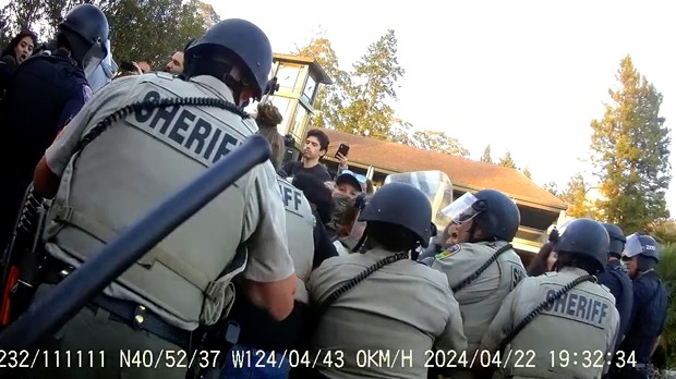 Police shove a group of protesters back, away from the entrance to Siemens Hall, on April 22 on the Cal Poly Humboldt campus.