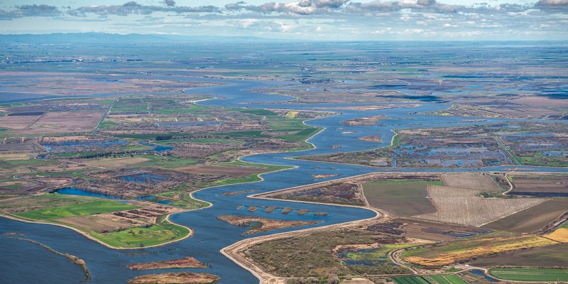 Aerial view looking north along Middle River left of the river is Mandeville Island and on the right is McDonald Island, both part of the Sacramento-San Joaquin River Delta in San Joaquin County, California. Photo taken March 08, 2019.