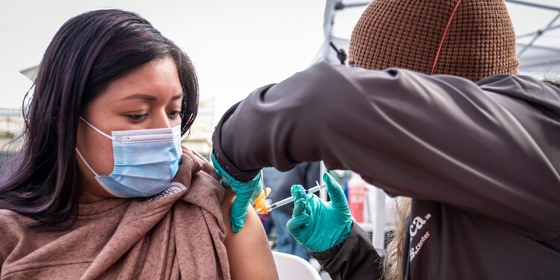 Florinda Matias Pablo receives a COVID-19 vaccination at the La Clinica de la Raza community vaccination site in Oakland on Jan. 4, 2022.