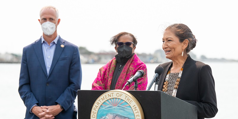 Flanked by Congressman Jared Huffman and Council on Environmental Quality Chair Brenda Mallory, U.S. Secretary of the Interior Deb Haaland speaks at a press conference about offshore wind power at the Woodley Island Marina.