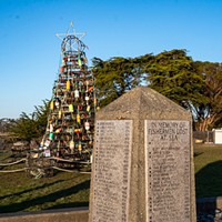 Woodley Island Walkabout Slideshow A four-sided memorial that lists the names of local fishermen lost at sea stands near the crab pot Christmas tree and "The Fisherman" statue. A collection of personalized items rests at the base of the memorial. Photo by Mark A. Larson