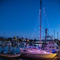 Woodley Island Walkabout Slideshow A walk along the Woodley Island Marina after sunset reveals Alan Workman's sailboat, Belle France, with its holiday lighting and a good view of the Carson Mansion across the bay with its holiday lighting. Photo by Mark A. Larson