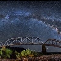 The Milky Way arcs from horizon to horizon above the South Fork Bridge in this panorama on the Main Fork Eel River, Humboldt County, California. July, 2018.
