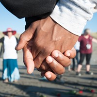 Vigil attendees joined hands in a circle to remember David Josiah Lawson.
