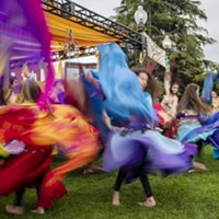 A slow shutter speed allowed the colorful costumes of the belly dancing group Ya Habibi in front the Enchantment Stage to blur in the photo.