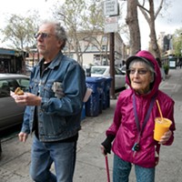 Dolores Helman, 93, and her son Elliot Helman, 64, go for a walk in Berkeley on March 15, 2020, as Gov. Gavin Newsom calls for isolation of all elderly people and those with chronic health conditions in response to growing concern over the coronavirus.