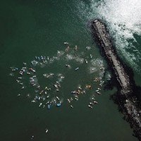 Humboldt surfers, paddle boarders and kayakers perform a ceremonial paddle out for black and brown people killed by police.