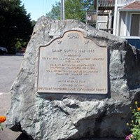 A historic plaque describes Camp Curtis, which sat in the hills of Arcata from 1862 to 1865 and housed the 1st Battalion California Volunteer Mountaineers, which committed acts of genocide.