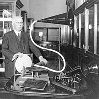 Emile Berliner (1851-1929) with a pair of his inventions, including the 1888 Gramophone (on right), circa 1920.