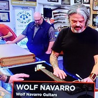 Wolf Navarro inspecting a vintage Fender on Pawn Stars.