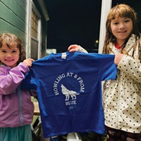 Shelby (left) and Alexis Wickizer display a t-shirt somebody dropped off at their house in appreciation of their persistent nightly howling.