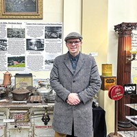 Josh Buck by the Samoa Cookhouse stove on display at the Clarke Historical Museum.
