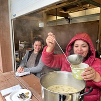 Dianna Beck looks on as Kayla Maulson serves chowder with traditionally harvested mussels.
