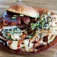 The juicy chicken katsu sandwich accompanied by sauce-drenched fries.