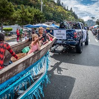 This traditional redwood canoe carried Darlene Rose McGee and others throwing candy to attendees of the Klamath Salmon Festival parade.