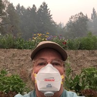 Dottie Simmons of Simmons Natural Bodycare wears a specialty protective mask to garden at her home in Dinsmore.