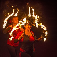 Circus of the Elements performers Loreta Flemingaite (left), of McKinleyville, and Chakeeta Marie Garabedian, of Trinidad, fire-dancing at Elemental: An Outdoor Pageant Spectacle.